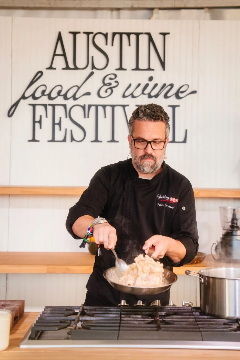 Chef Fabio Viviani preparing a dish at the Austin Food and Wine Festival