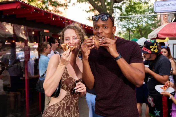Customers enjoy slices outside at L'industrie Pizzeria in Brooklyn, New York.