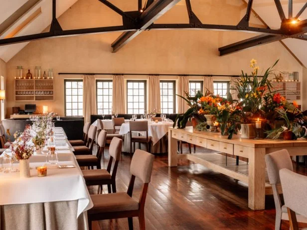 Tables sit inside the dining room of the Blue Hill at Stone Barns restaurant in Pocantico Hills, New York, U.S., on Friday, April 21, 2017. As customers are increasingly demanding free-range meat from smaller producers, just a handful of large slaughterhouses handle a disproportionate amount of that American meat: of those approximately 1,100 facilities, 215 large slaughter establishments produce about 75 percent to 90 percent of the country's volume.