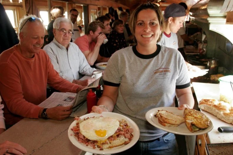 A waitress serving food at Franks Diner. (Photo by: Jeffrey Greenberg/Universal Images Group via Getty Images)