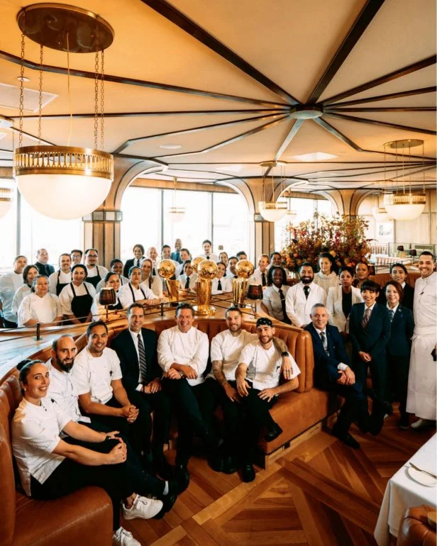Dozens of crew of the Miller & Lux staff pose in and behind the booths at the restaurant.