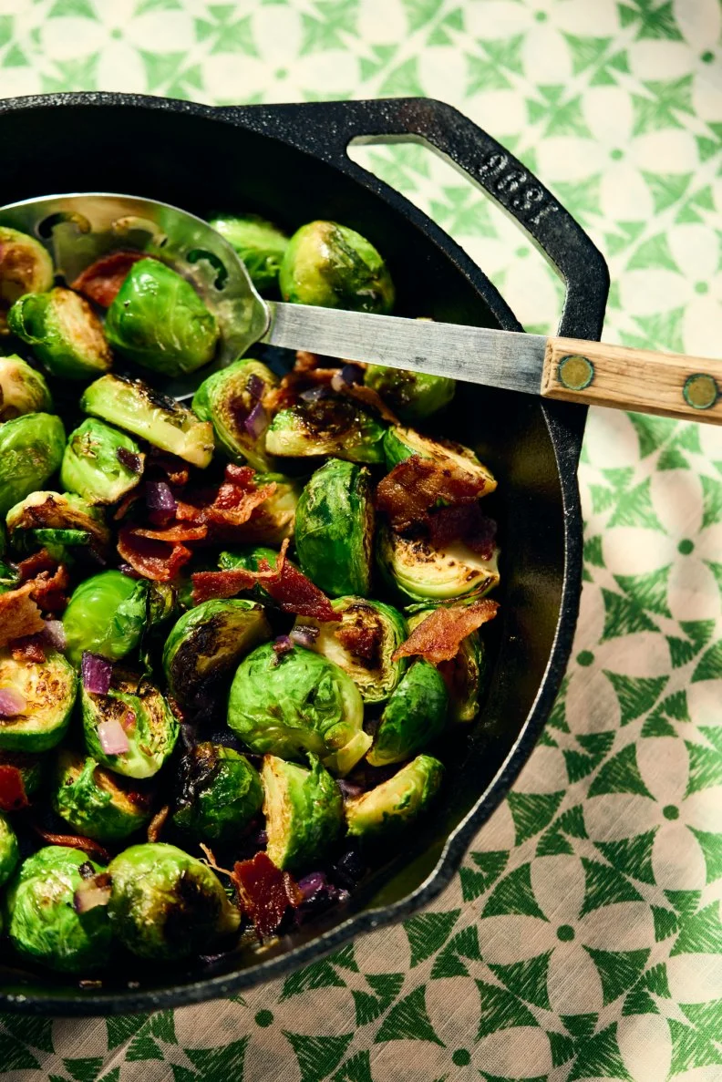 A skillet of Pan-Fried Brussel Sprouts with Bacon made by Kardea Brown