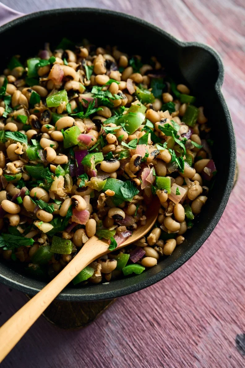 A skillet of Quick Black-Eyed Peas made by Kardea Brown, author of Make Do With What You Have