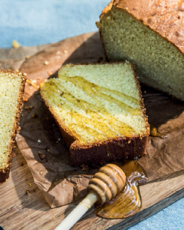 A close-up of sliced cornbread with a drizzle of honey