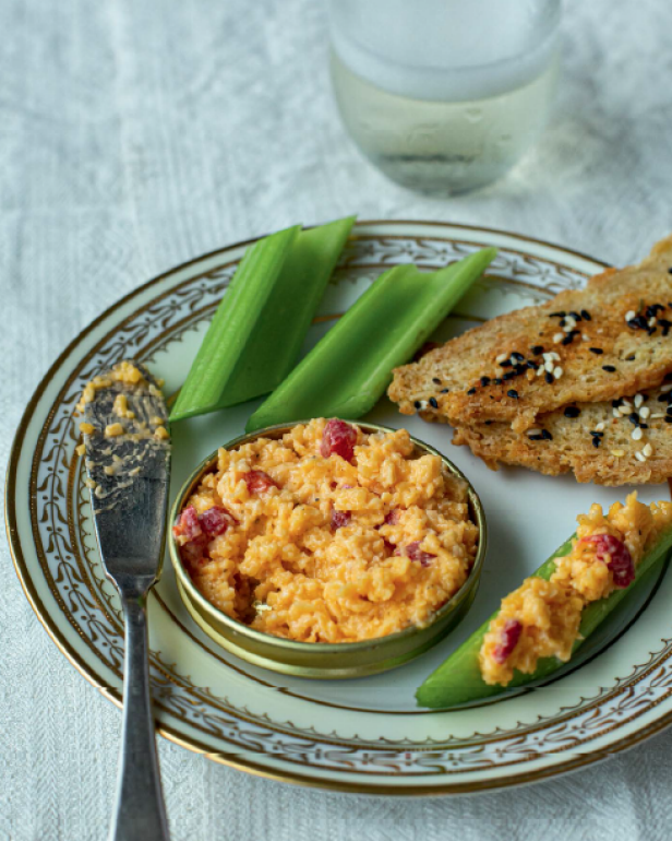  A plate of pimento cheese, celery sticks and toast beside a water glass