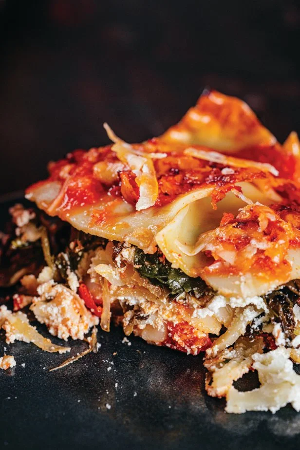 Lasagna layered with tomato sauce, noodles, cheese, and seaweed.