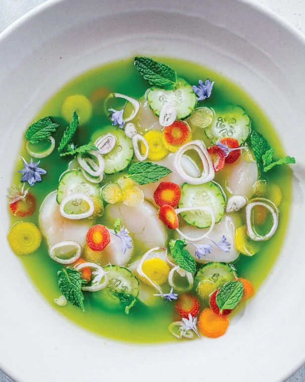 Raw scallops and calamari with mint leaves, shallots in green broth.