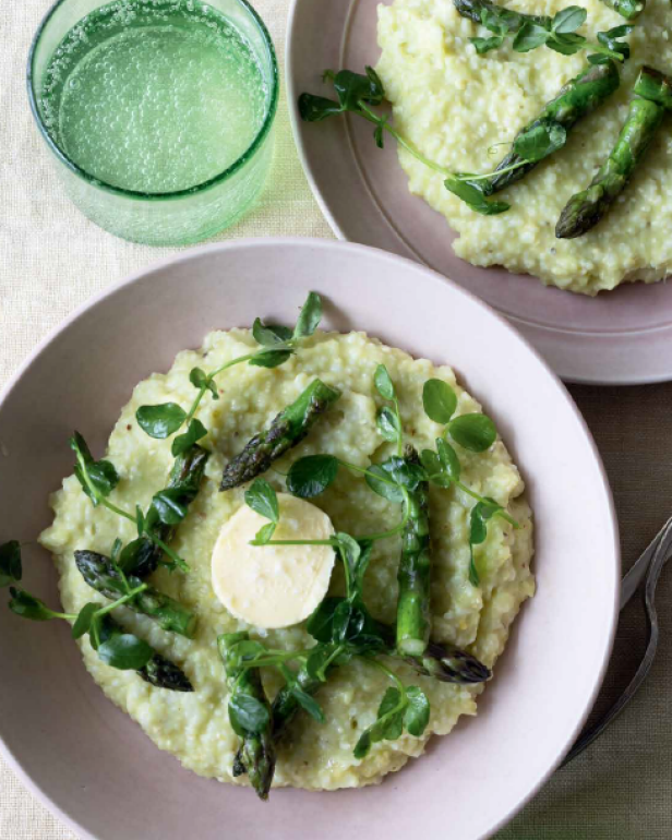 Bowls of Suzanne Vizethann's Asparagus Grits on a table with a glass of water