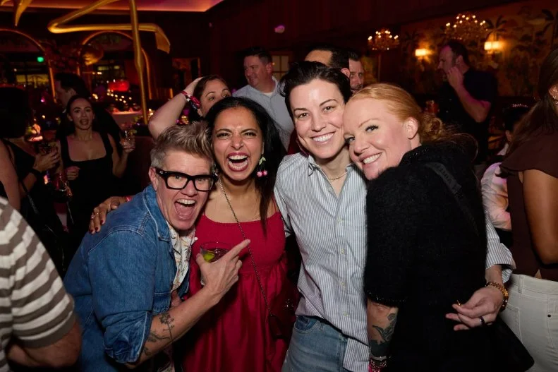 Chefs pose and smile at the camera at a party at Pink Steak at Palm Beach Food and Wine Festival.
