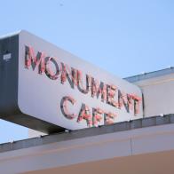 Exterior sign at Monument Cafe in Austin, Texas, as seen on Food Network's Triple D Nation, season 8.