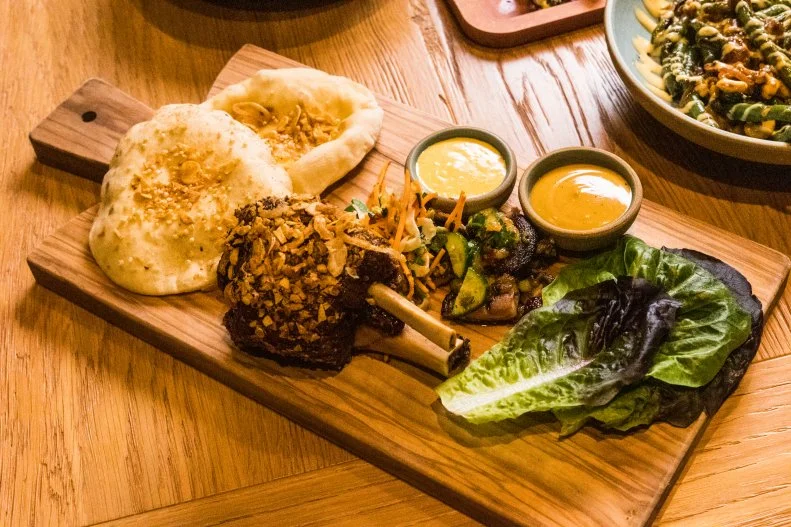 Sticky glazed pork shank at Girl and the Goat in downtown Los Angeles, as seen on Bobby and Sophie Take the Coast, Season 1.