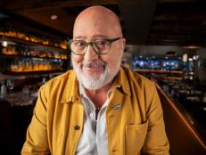 Close up of Andrew Zimmern smiling to camera