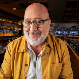 Close up of Andrew Zimmern smiling to camera