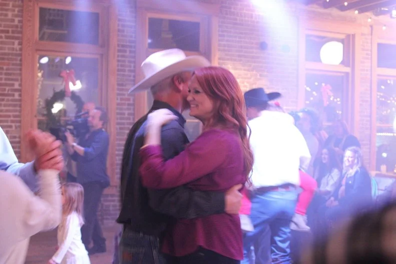 Host Ree Drummond and Ladd Drummond dancing at a party, as seen on Food Network's The Pioneer Woman: Cowboy Christmas Special.
