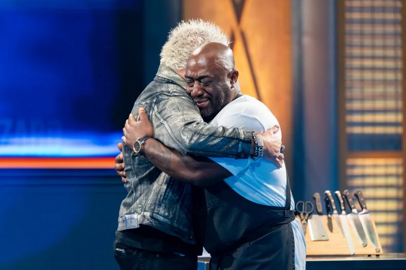 Host Guy Fieri and contestant Kenny Gilbert react as Kenny Gilbert is announced the winner of the round, as seen on Tournament of Champions, Season 7.