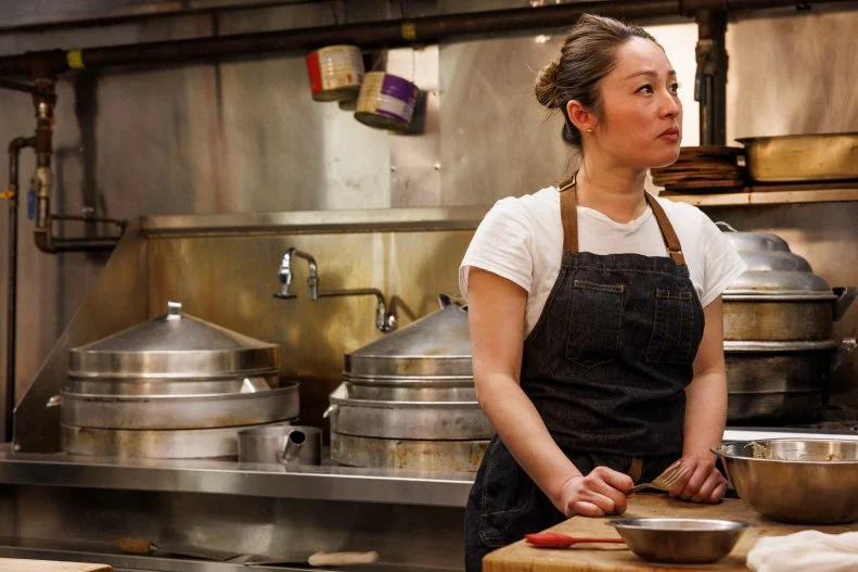 Joanna L in the kitchen with a focused facial expression