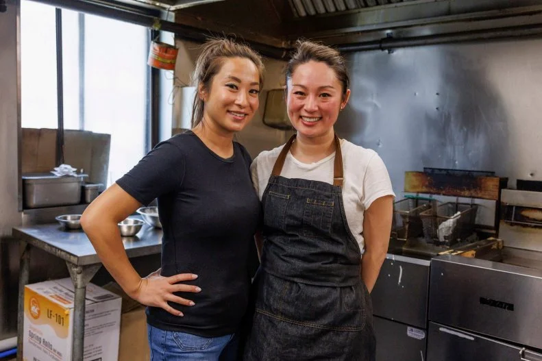 Jeanette L and Joanna L pose for a portrait in the kitchen