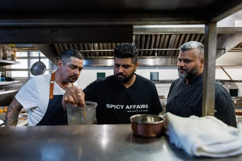 Host Aaron Sanchez with restaurateurs Lovato Varma and Johny Varma, in the kitchen of restaurant Spicy Affairs, as seen on Restaurant Impossible: Last Call, Season 1