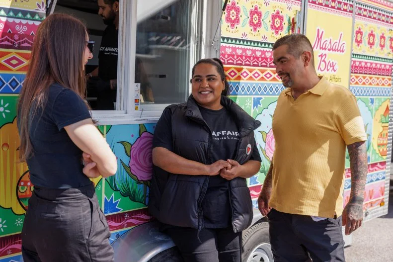 Aaron Sanchez and Jen Agg smiling with Aysha S in front of food truck