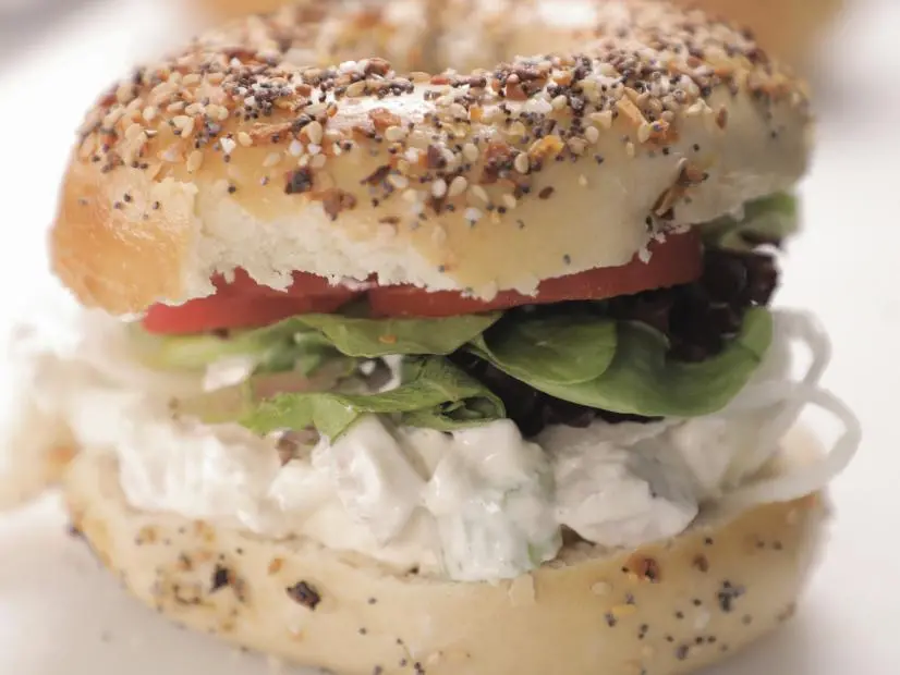 Chicken Salad Bagel Sandwich on an Everything Bagel as prepared by chef Jeff Pietila at Krave Bagel in Myrtle Beach, South Carolina, as seen on Food Network's Diners Drive-Ins and Dives, season 44.