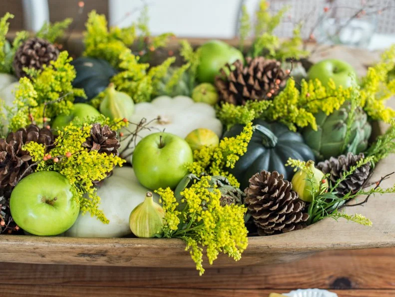If you don’t have an antique wooden dough bowl at your disposal, many reproductions can be found at chain home décor stores.  This idea would also work with a metal or wood trough, a crate or even a shallow basket.  Just find something with the right shape and scale for your table.