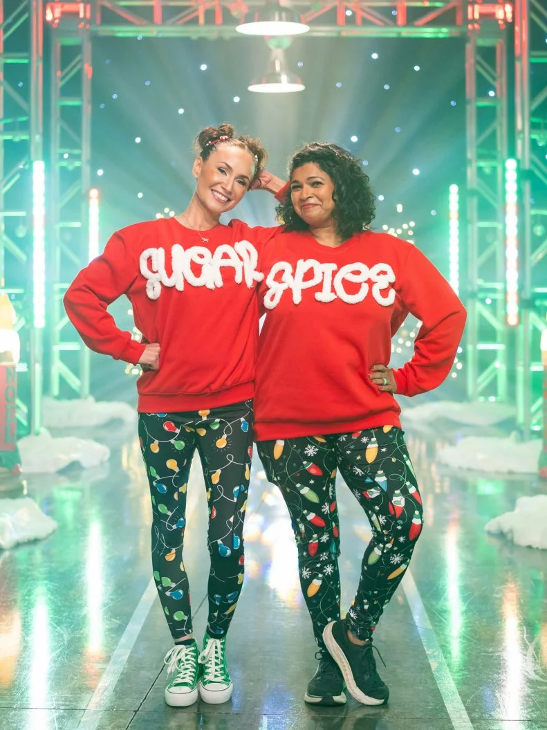 Contestants Stephanie Boswell and Aarti Sequeira pose, as seen on Tournament of Champions: All-Star Christmas, Season 2.