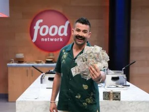 Chef Joe Sasto showing off his winnings , as seen on the Food Network's Guy's Grocery Games.