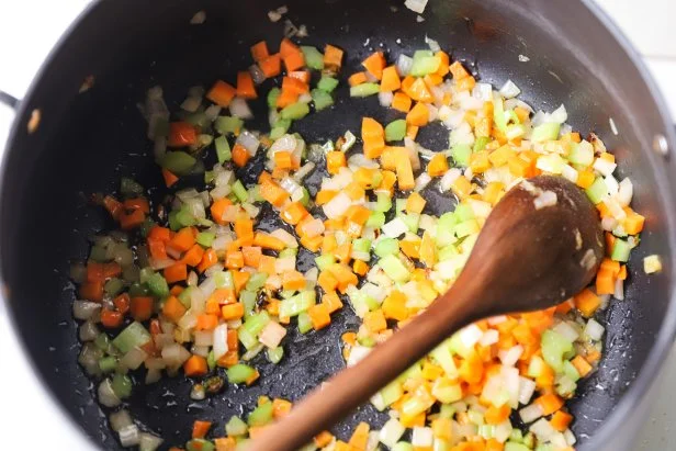 Chopped celery, onions and carrots searing in a stockpot
