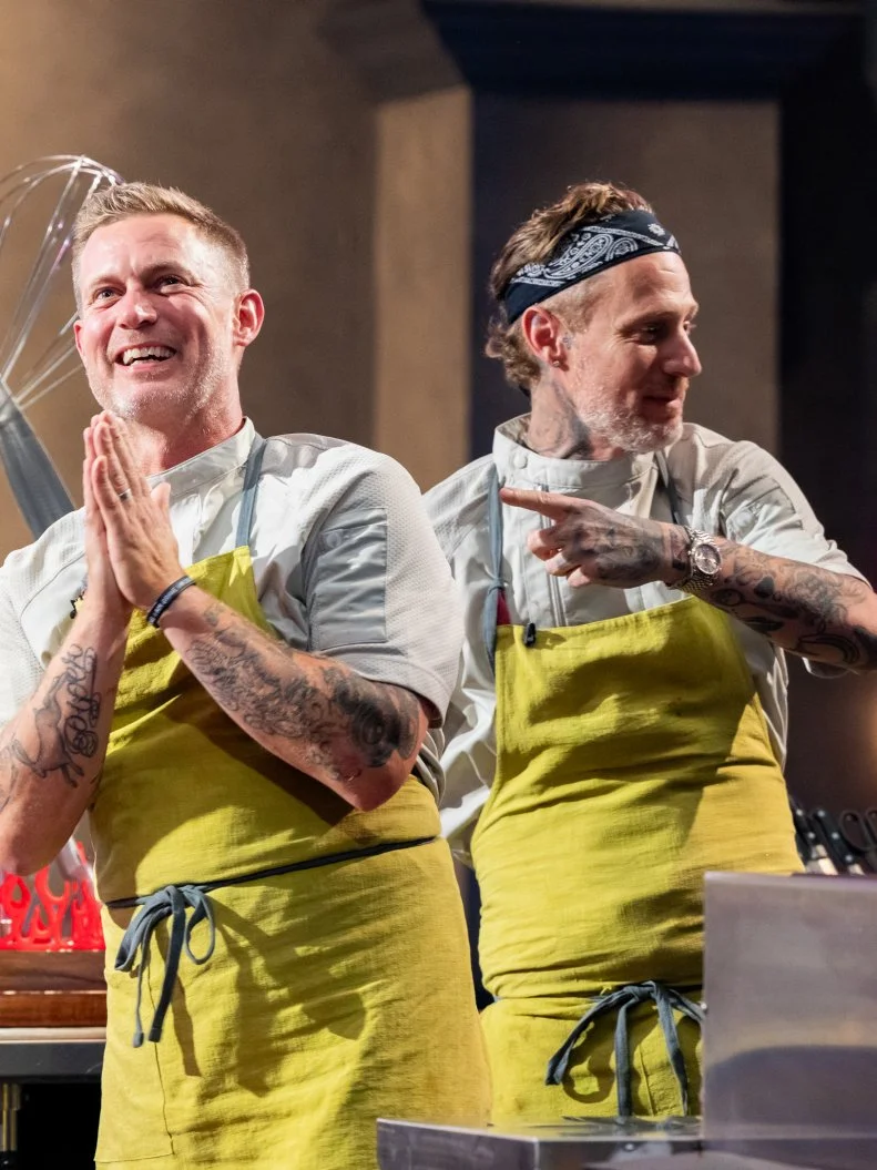 Contestants Michael Voltaggio and Bryan Voltaggio react as Michael and Bryan are announced the winners of Tournament of Champions Holiday, as seen on Tournament of Champions Holiday, Season 1.