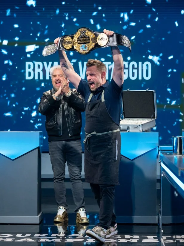 Host Guy Fieri and contestant Bryan Voltaggio reacts as he is announced the Tournament of Champions, Season 7 winner, as seen on Tournament of Champions, Season 7.