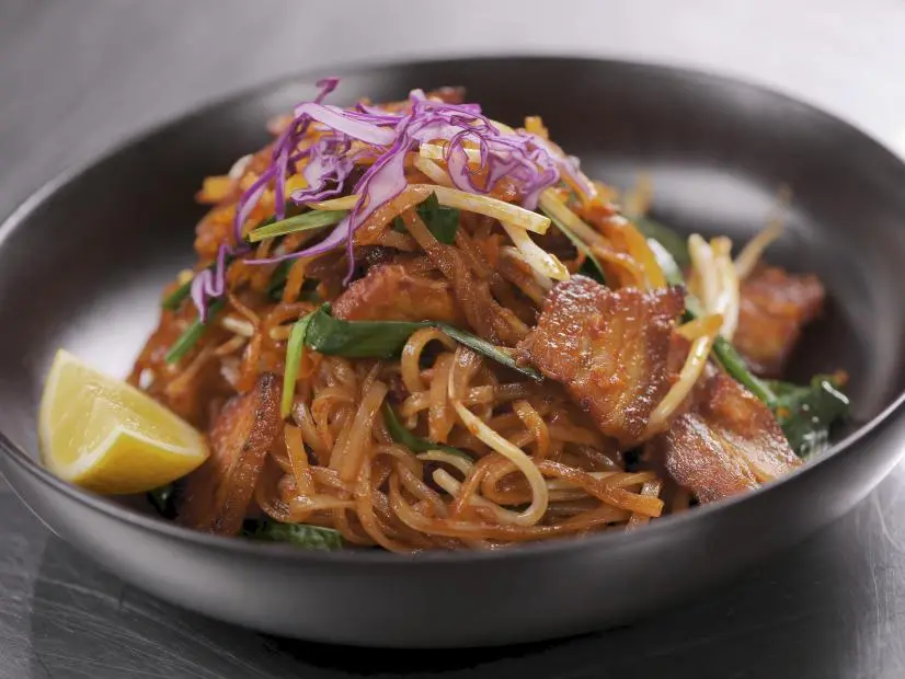 Angkor Noodles with Pork Belly as prepared by Chef/Owner Channy Laux at Angkor Chef in San Jose, California, as seen on Food Network's Diners Drive-Ins and Dives, season 42.