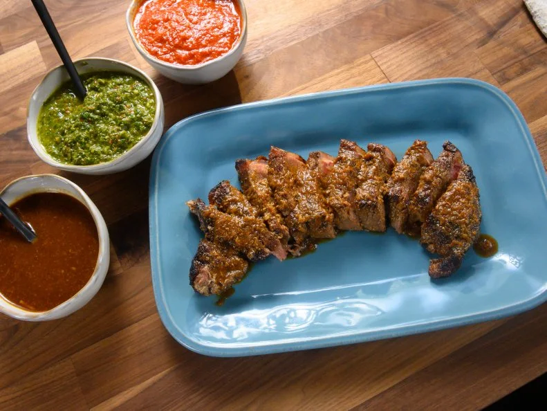 Host Rachael Ray's steak with miso ginger steak sauce, Spanish steak sauce, and salsa verde, as seen on Food Network.