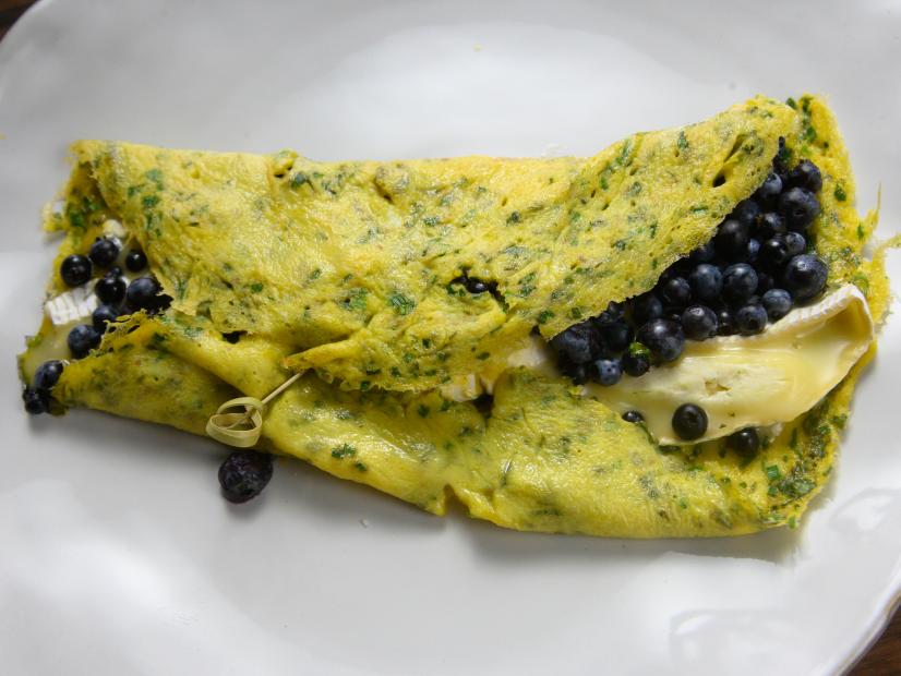 Host Rachael Ray's egg crepes with herbs, soft cheese and blueberries, as seen on Food Network.