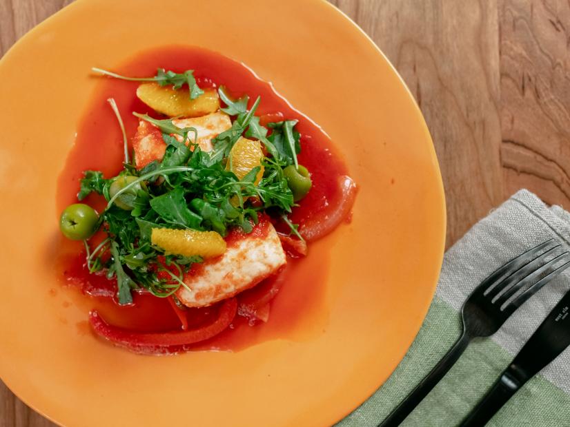 Michael Symon features Tomato-Poached Halibut with Arugula, Olive and Orange Salad, as seen on Food Network Kitchen Live.