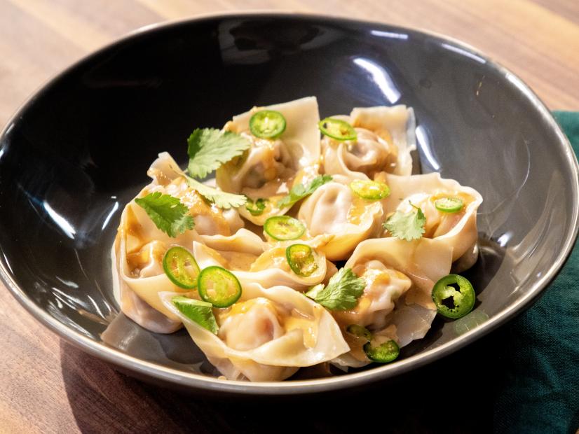 Ronnie Woo posing with Pork and Shrimp Wontons w/ Peanut Sauce, as seen on Food Network Kitchen Live.