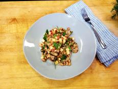 Pork and beans: happiest marriage ever. I've taken this perfect food couple and lightened it into a weeknight dish. Tenderloin gets even juicier after a garlicky marinade and a turn on the grill. It's topped with crunchy apple and creamy black-eyed peas mingled in a refreshing vinaigrette.