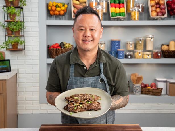 Jet Tila posing with Grilled Korean BBQ Beef Short Ribs, as seen on Food Network Kitchen Live.