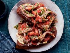 There are so many anchovies to choose from at the supermarket. I always aim for the ones in a glass jar or in any packaging where I can actually see the fillets. I look for pristine, firm fillets, with their silvery skin or without, that look like an invitation to eat! For this recipe, I like the pure taste of fish simply packed in a neutral oil or olive oil and without excessive herbs or spices.

Piquillo means 'little beak' in Spanish. Named for their shape, these peppers are sweet and come fire-roasted and peeled. The result? A luscious ready-to-eat red pepper with great texture.

I like to put the cold, straight-from-the-fridge anchovies on the warm toast for a temperature contrast.