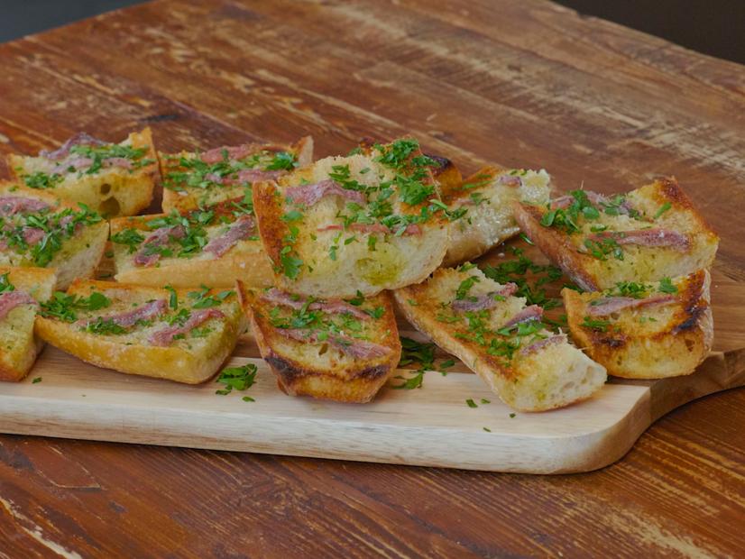 Antonia Lofaso makes Anchovy Toast with Garlic on Antonia Lofaso's Feast of Seven Fishes, as seen on Food Network Kitchen.