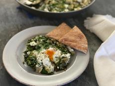 Shakshuka has earned a fashionable following these days, appearing on all the trendy restaurant menus and Instagram feeds. It is a traditional North African and Middle Eastern dish of eggs simmered in a skillet of spiced tomato sauce that can be served for pretty much any meal of the day. But while the red-sauce version is most typical, there are many creative variations possible. This version goes all green with a base of spinach and artichokes seasoned with cumin, coriander, garlic, and a hint of peppery heat, then topped with salty, creamy feta and fronds of fresh dill. It is out of the ordinary in the best possible way. Enjoy it scooped up with warm pita bread.