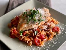 This recipe spins a classic puttanesca sauce of tomatoes, garlic, olives, and capers into a single-skillet meal by cooking chicken breasts in the pan to start, then making the sauce and cooking the orzo pasta together in the same pan. Convenience is not the only benefit&mdash;the method adds flavor, too, as the fond (the brown bits left in the pan) from the chicken flavors the sauce and the pasta both absorbs and thickens it. Served sprinkled with Parmesan and fresh basil, it gives new life to an old favorite.