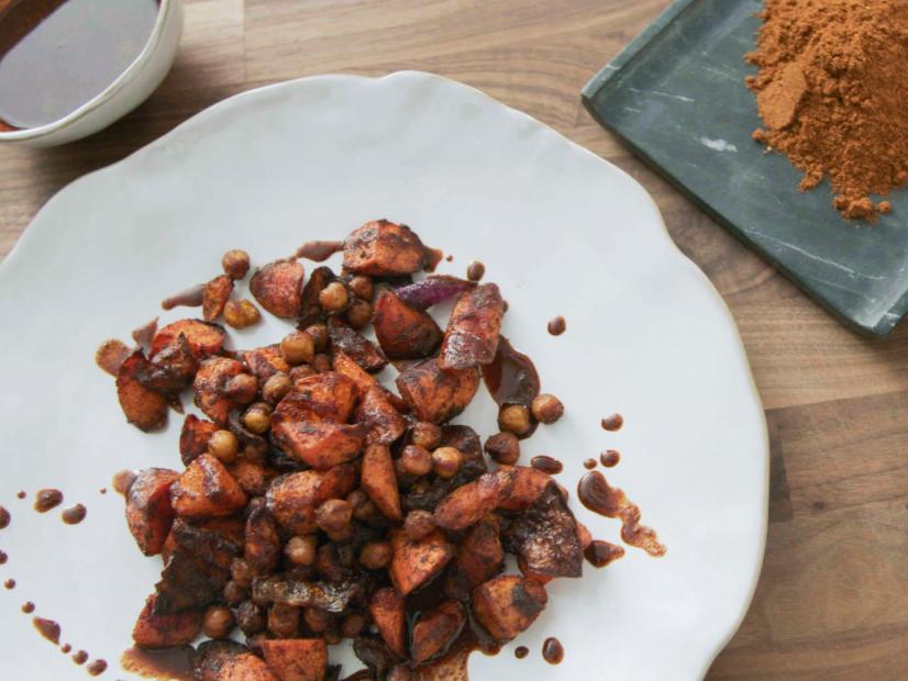 Host Hawa Hassan displays her Berbere-Spiced Roasted Carrots, Chickpeas and Onions at home, as seen on Food Network Kitchen's Hawa at Home