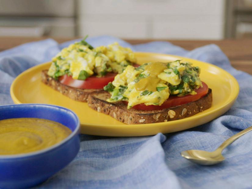 Host Hawa Hassan displays her Herbed Egg Breakfast Toast with Hot Pepper Sauce at home, as seen on Food Network Kitchen's Hawa at Home
