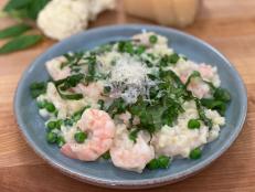 This dish is a satisfying mash-up of two comfort food classics&mdash;cauliﬂower with cheese sauce and risotto with shrimp and peas&mdash;which makes for a healthy, modern, and doubly comforting skillet dinner. The cauliﬂower, which has been grated so it resembles rice, is simmered brieﬂy with ﬂour-thickened milk and Parmesan cheese, forming a creamy sauce to coat the vegetable and create a risotto-like base. Shrimp and peas are added to the skillet, and minutes later the dish is ready to be served, garnished beautifully with ribbons of fresh basil and a shower of Parmesan.