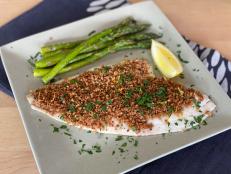 My mom often served a version of this dish when I was a kid, and it was one of my favorites. I guess it makes sense that it has become one of my go-to fast and easy dinners too. It&rsquo;s a weeknight trifecta&mdash;simple, tasty, and family friendly. All you need to do is sprinkle seasoned buttered bread crumbs onto a white, flaky fish fillet, and in less than 10 minutes the fish is done and the bread crumbs are crisped. I made it healthier by using freshly made whole-grain bread crumbs (which are a cinch to make) and adding some olive oil to the mix to keep the butter minimal. Roasting asparagus right alongside makes it a real two-for-one. Enjoy with some whole-grain rice, quinoa, or orzo.