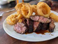 This is a simple recipe that makes everyone hungry. It's a good feeling to make your own onion rings and watch as people crunch down on them as they cut into this tasty steak. I serve the meat with a little vinegar so the onion rings get a salt and vinegar vibe when you eat the two parts of the dish together. This is not the type of dish that can be made in advance and held, so get everything ready and cook the meat and onion rings when you are ready to eat!