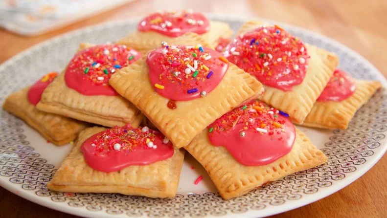 Pastry pockets with raspberry glaze and sprinkles
