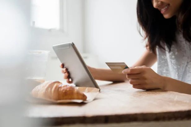 Mixed Race woman online shopping with credit card