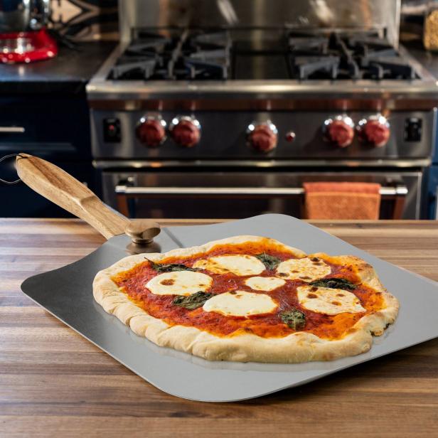 https://food.fnr.sndimg.com/content/dam/images/food/products/2021/4/28/rx_honey-can-do-14-folding-pizza-peel-with-handle-natural.jpeg.rend.hgtvcom.616.616.suffix/1619637139495.jpeg