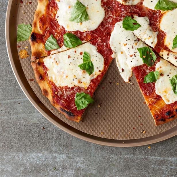 https://food.fnr.sndimg.com/content/dam/images/food/products/2022/1/25/rx_food-network-textured-performance-series-145-in-nonstick-pizza-pan.jpeg.rend.hgtvcom.616.616.suffix/1643131565840.jpeg